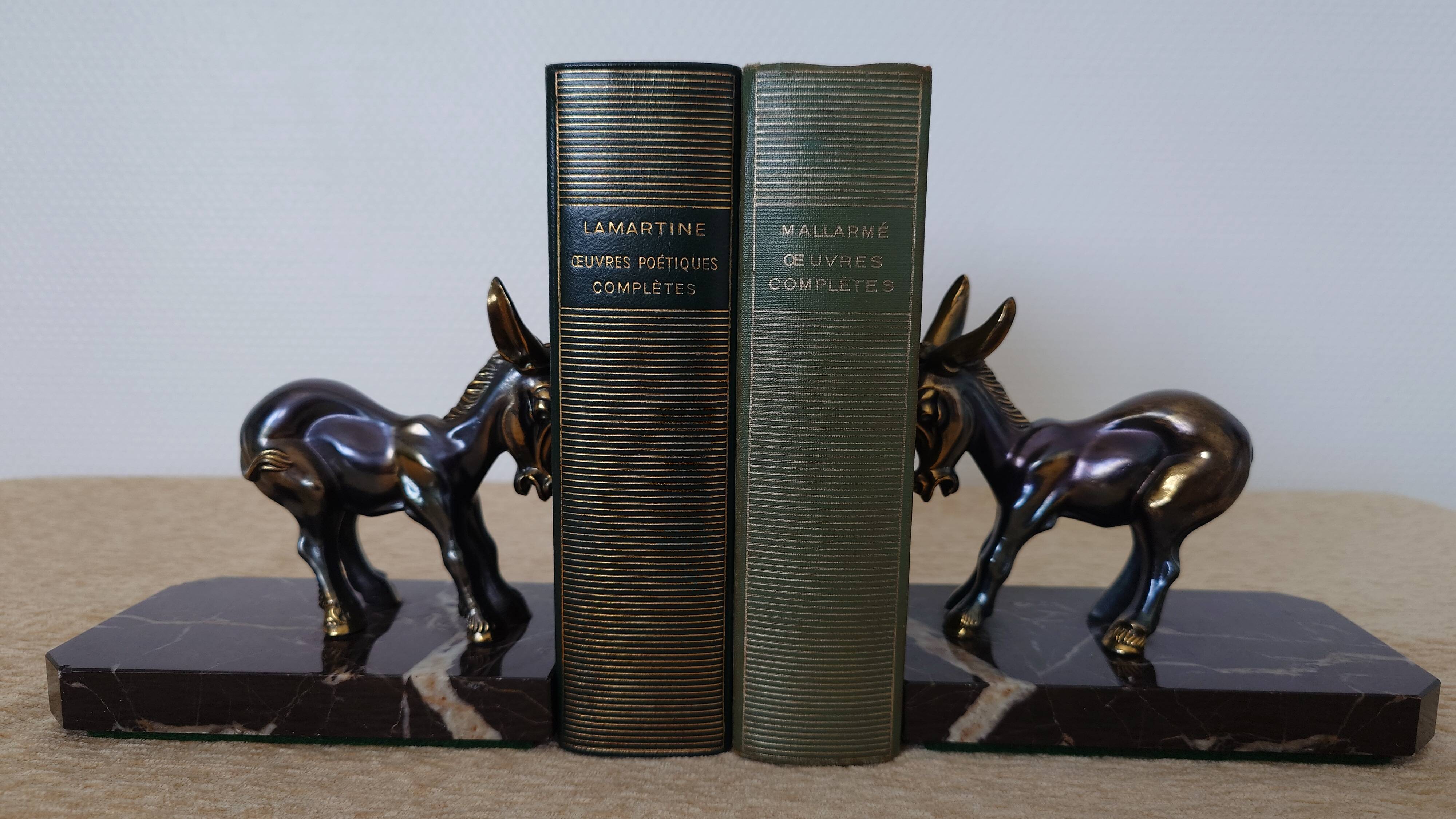 Bookends in the style of stylised donkeys, patinated metal and marble - circa 1940-1950.