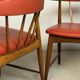 Pair of Scandinavian armchairs in teak and red faux leather – 1960s