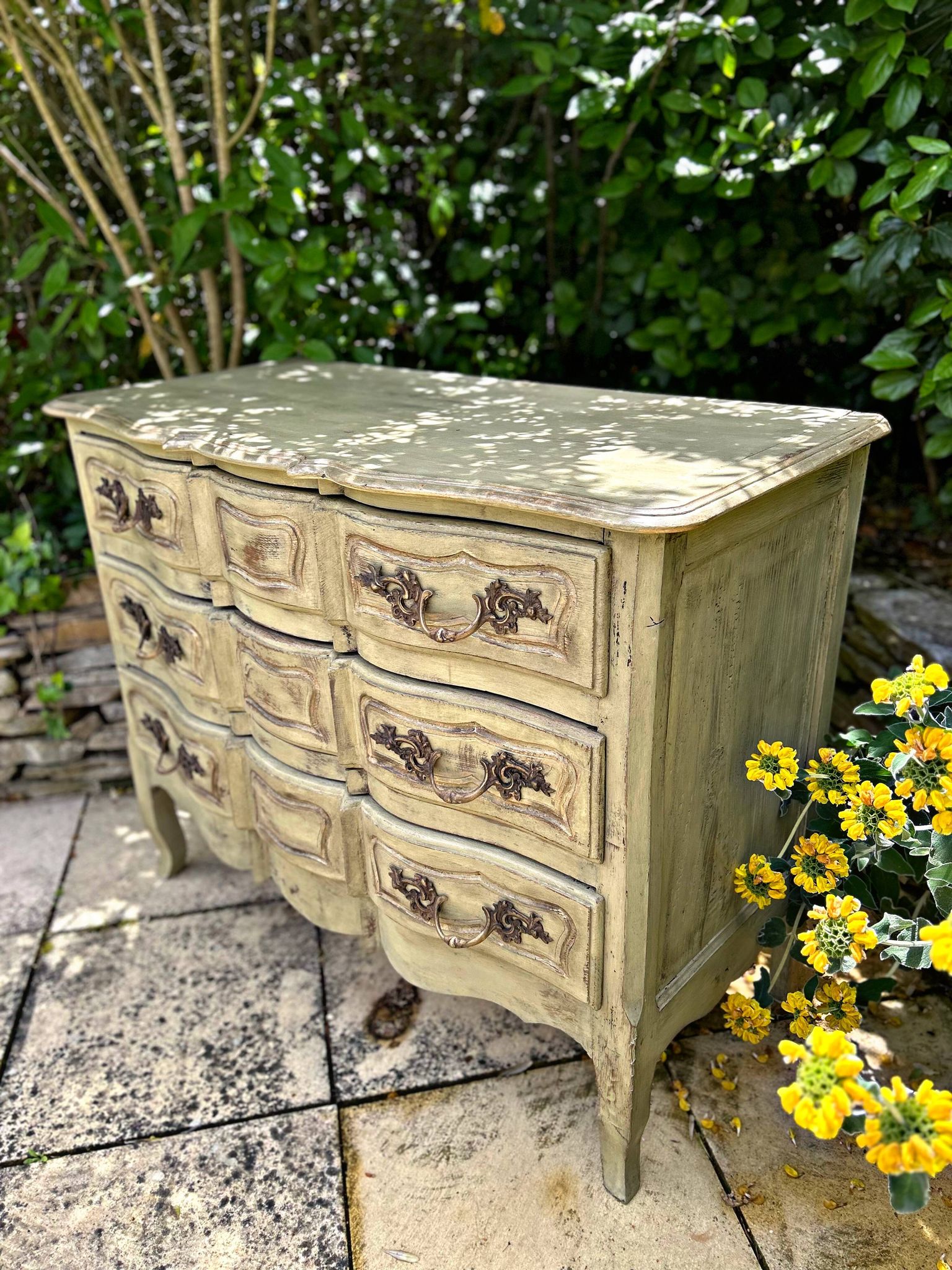 Curved antique commode in pistachio green patina.
