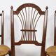 3 wooden and straw chairs, decorated with a sheaf of wheat.