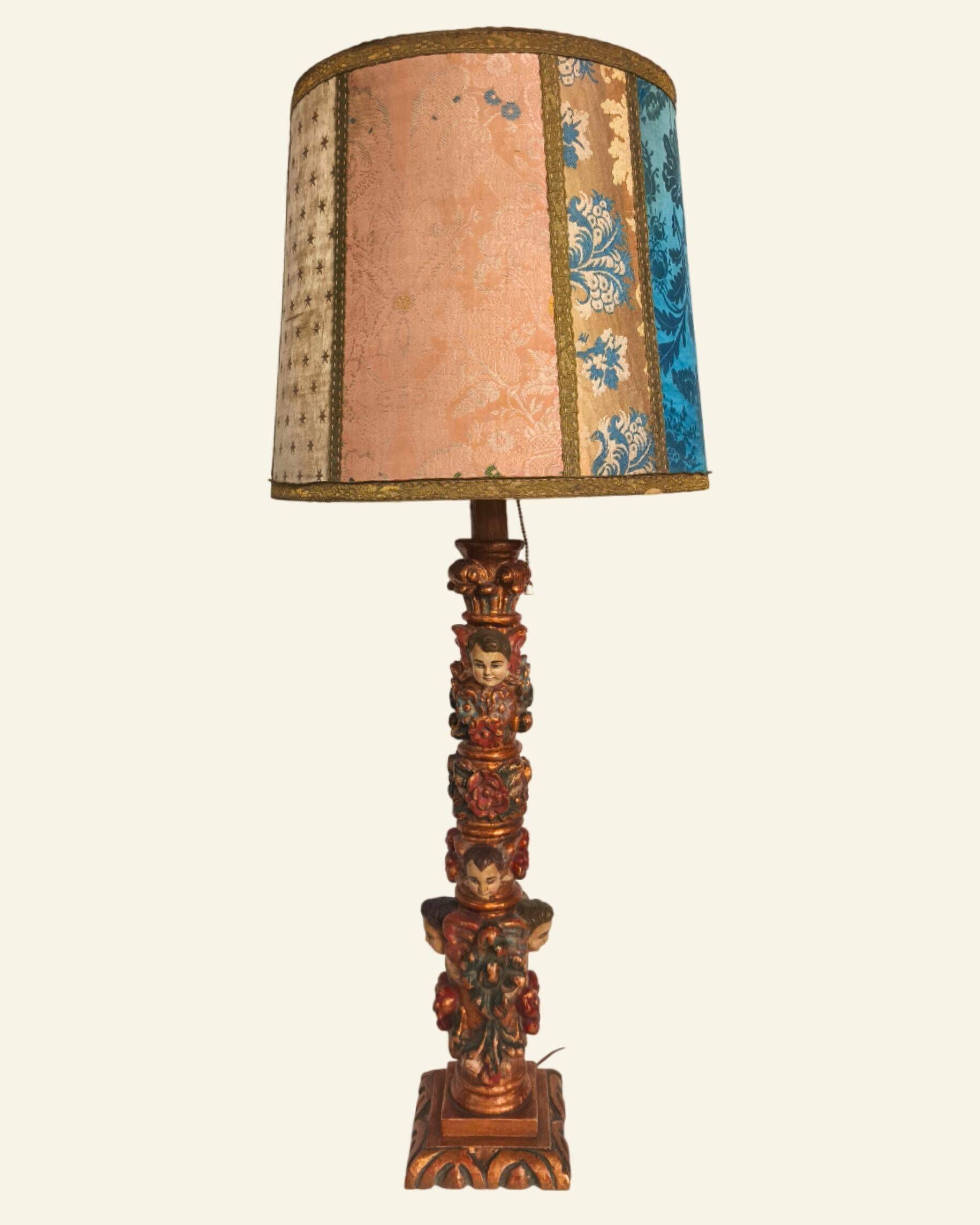 Renaissance table lamp in polychrome carved wood with cherubs.