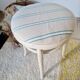 Vintage curved wooden stool in Baumann style, striped seat.