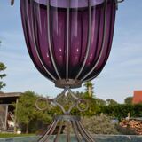 Large blown glass and wrought iron vase on shower stand