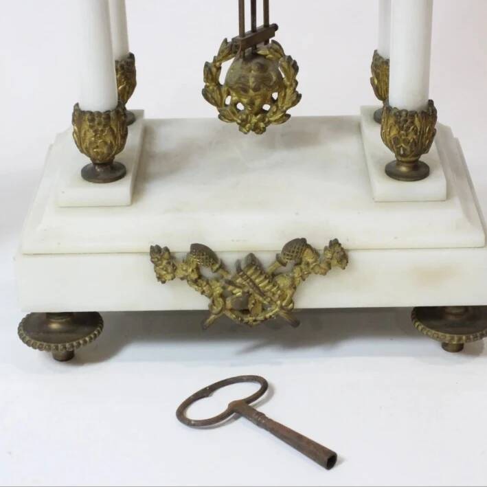 Clock and pair of Louis XVI style candelabras.