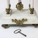Clock and pair of Louis XVI style candelabras.