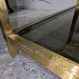 Table basse en métal doré et verre fumé