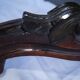 Gueridon en noyer à plateau violonné ouvrant par deux tiroirs en ceinture. Epoque Louis Philippe.