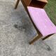 Mid-Century telephone bench in teak with bright pink fabric seat and wooden top.