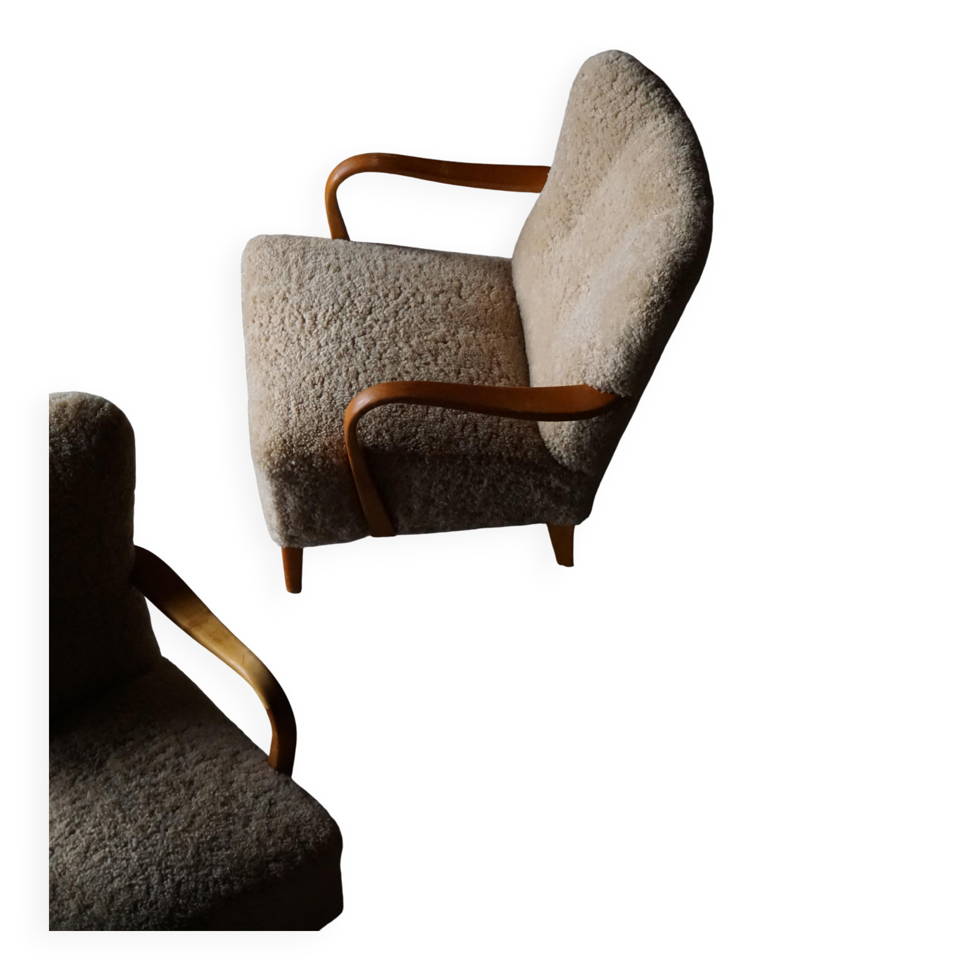 Pair of Mid Century Modern Swedish lounge chairs in birch and lamb's wool, 1960s.