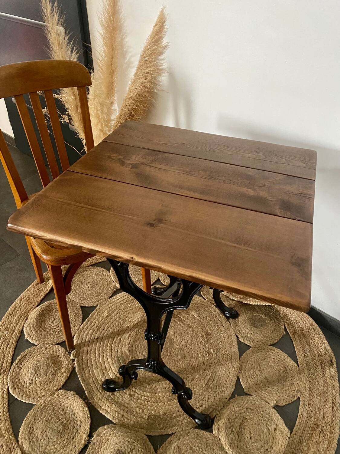 Bistro table with iron legs and raw wood top.