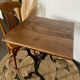 Bistro table with iron legs and raw wood top.