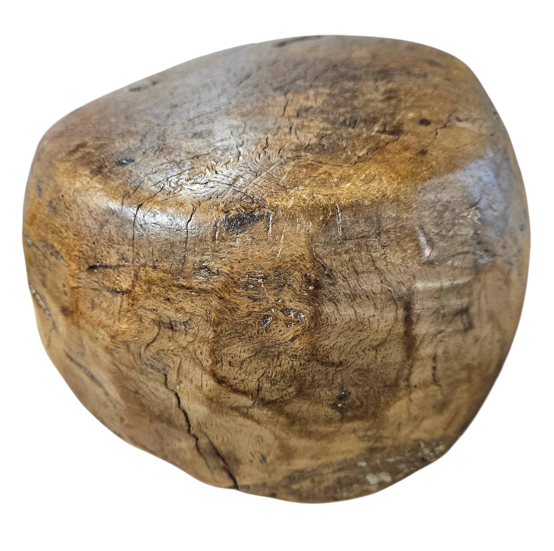 A substantial hand-hewn wooden bowl carved from a single burl section