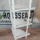 White lacquered corner shelf.