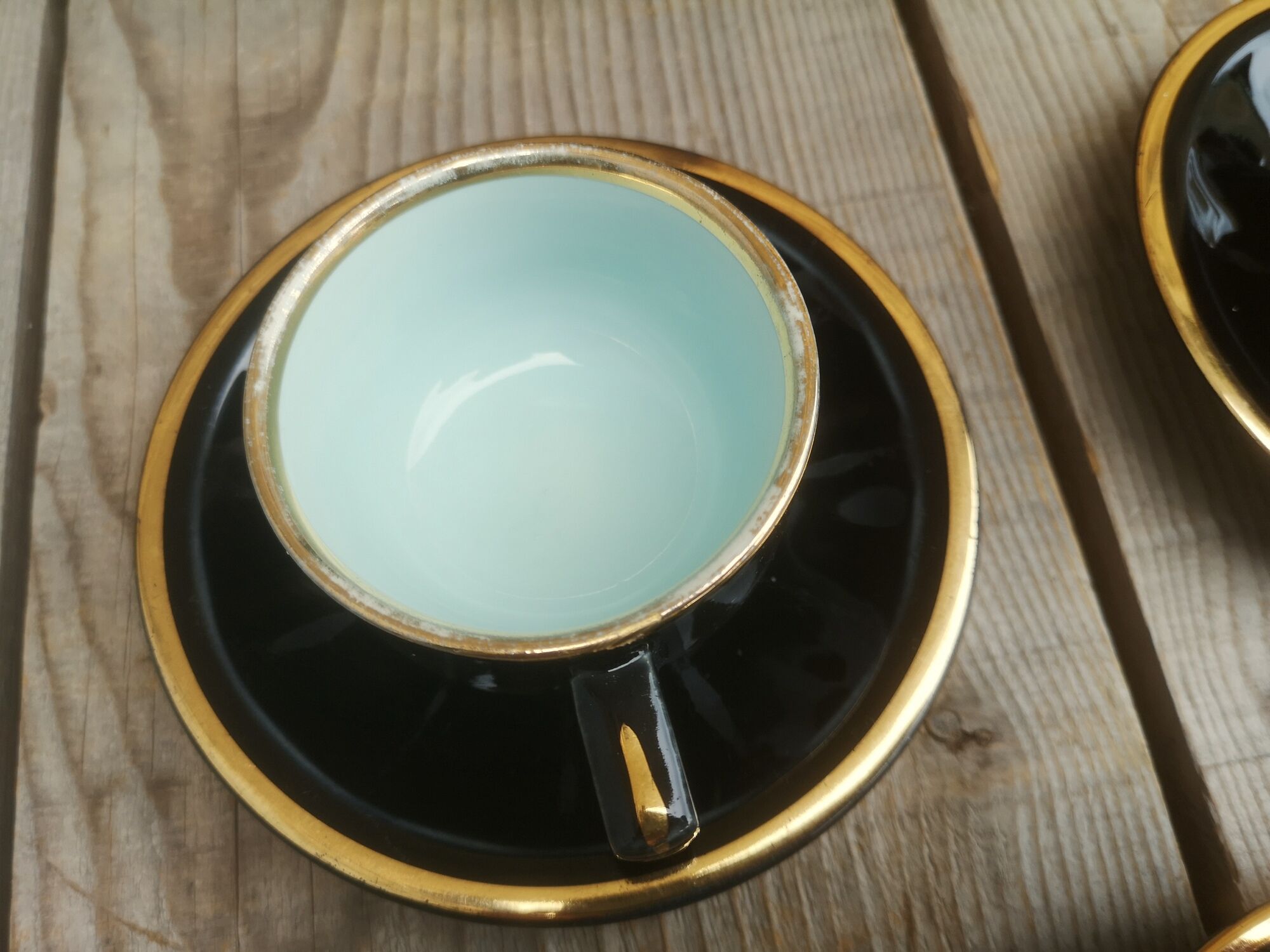 Set of 9 cups and sub-cups in black ceramic and colored gold border