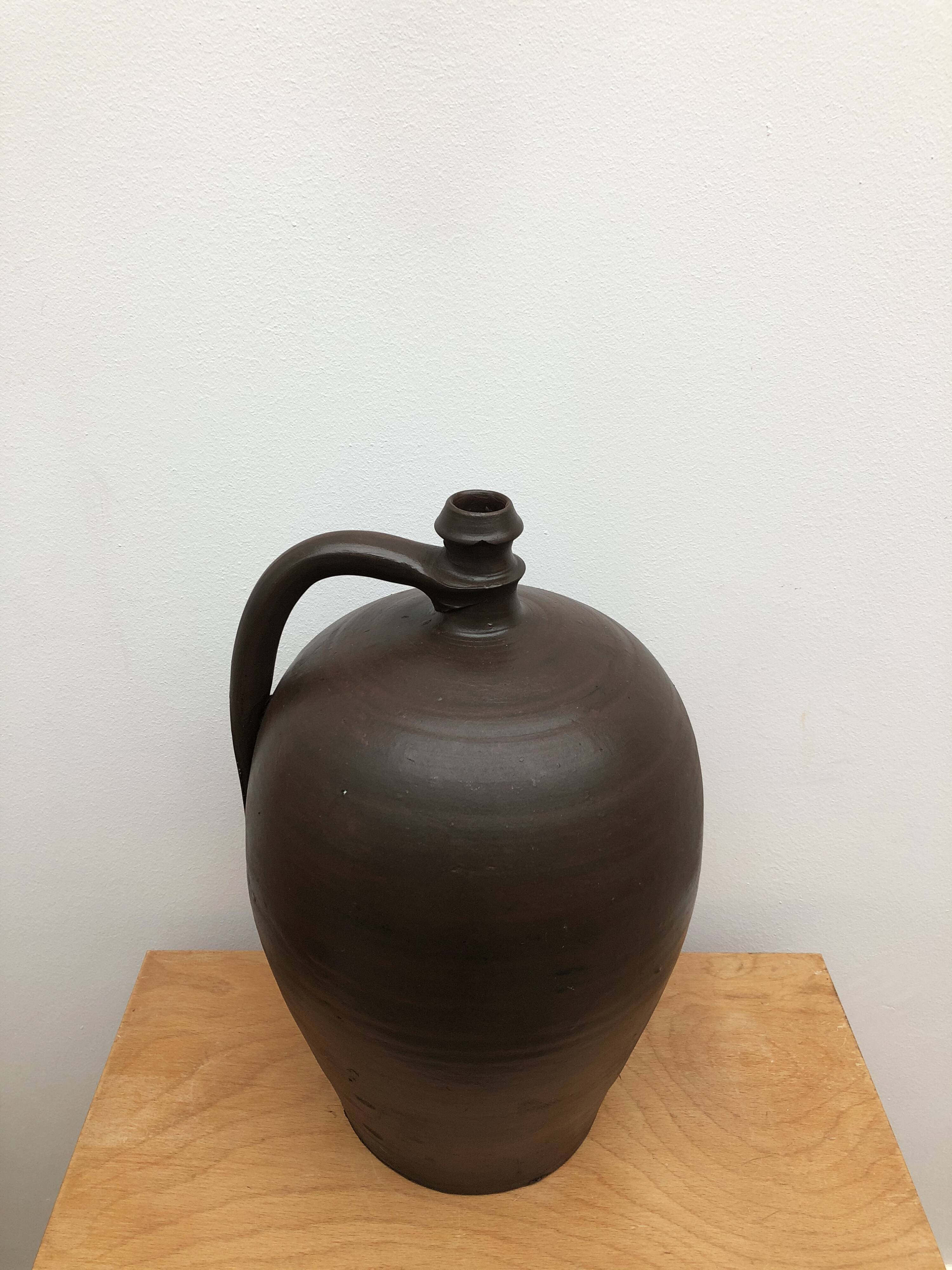 Ancient varnished sandstone jug