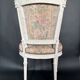 Antique Louis XVI style chair with patinated wood and floral fabric.