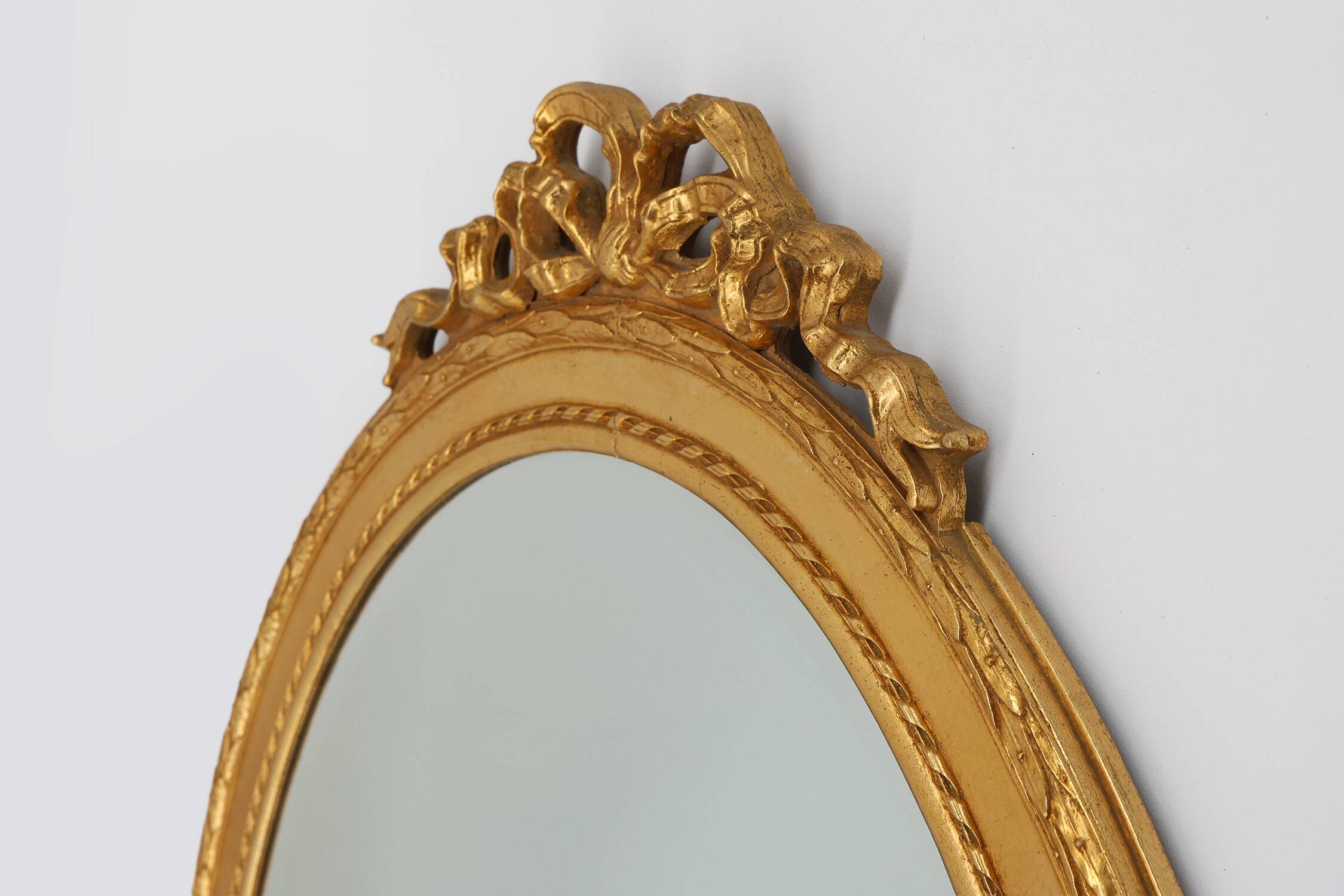 Oval shaped carved gilded Baroque mirror with beveled glass, Belgium