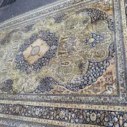 Large Persian wool rug 250x350 cm in gold and navy blue.