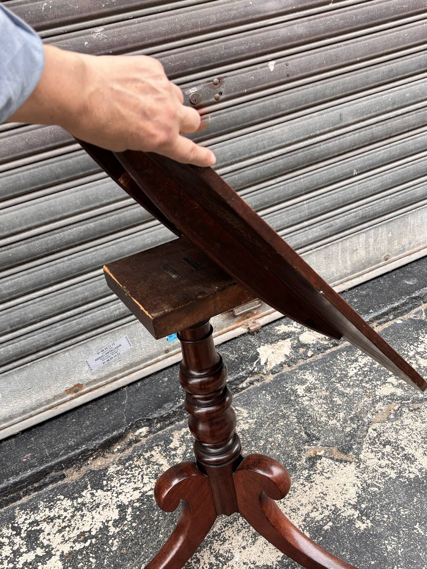 19th-century solid mahogany table with a tilting top and brass mechanism.