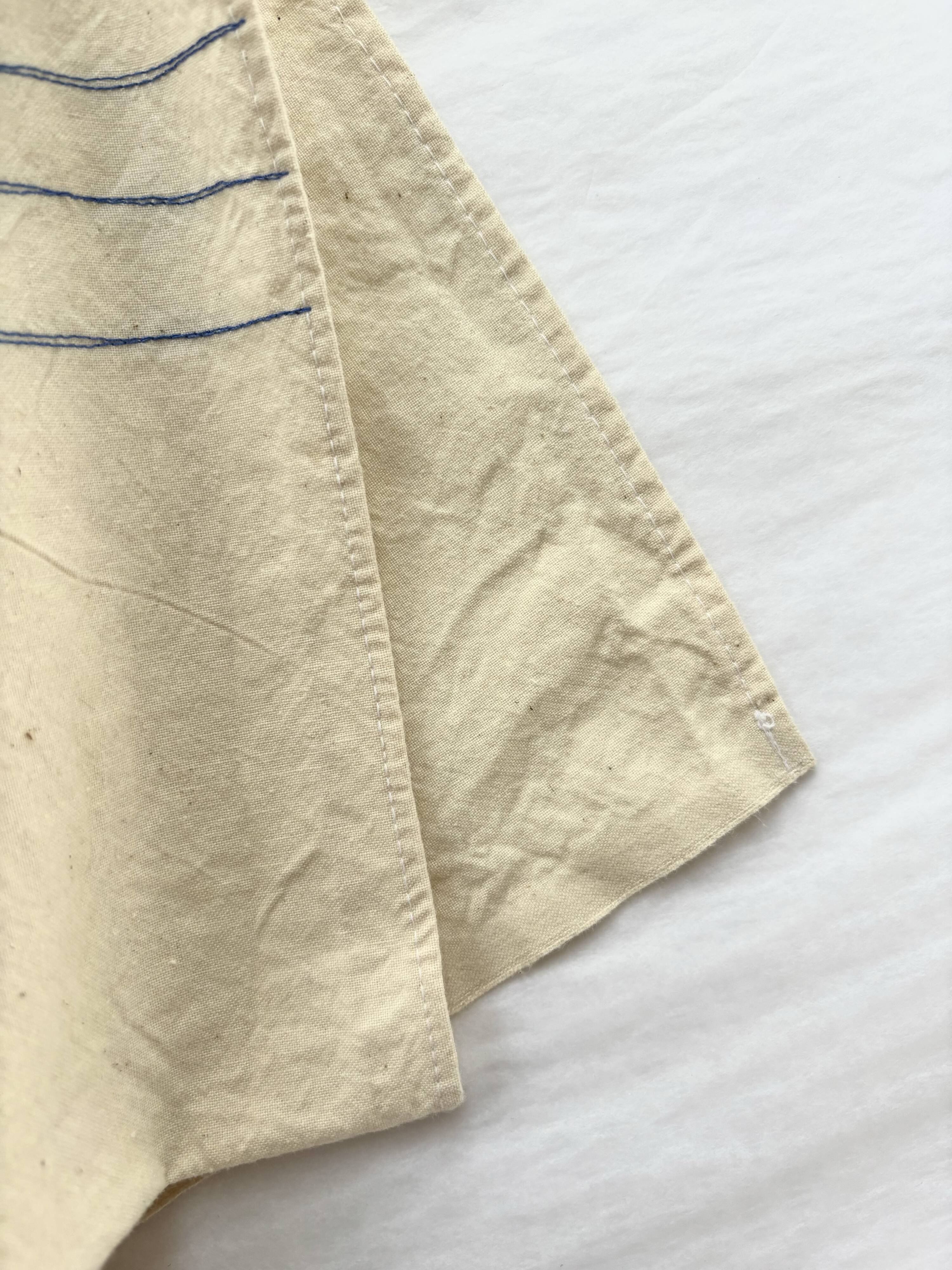 Nappe, écru, surpiqûres bleue/verte