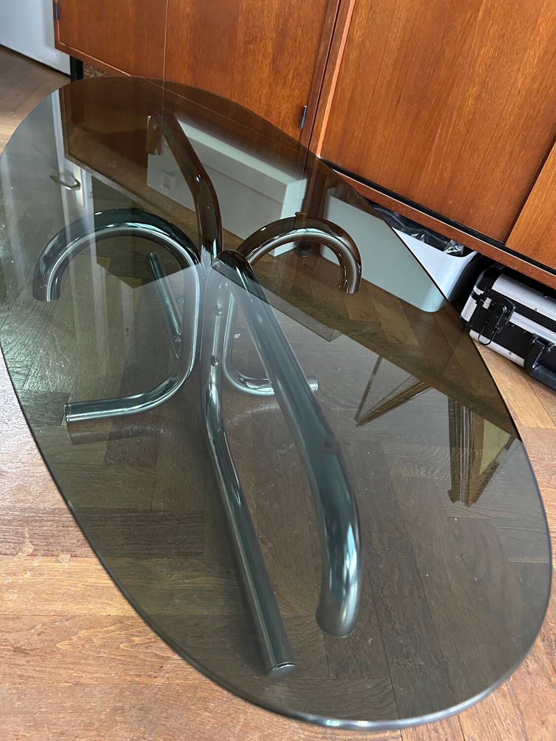 70s design oval coffee table in smoked black glass with chrome legs.