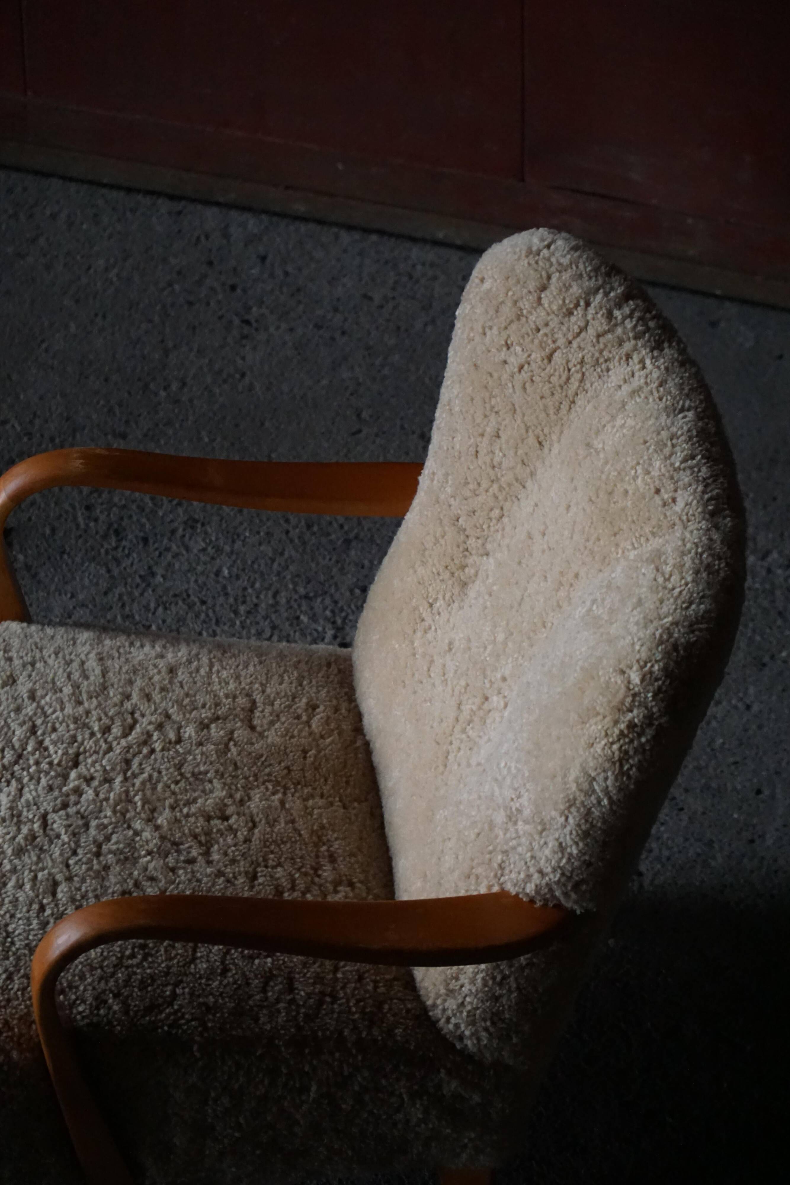 Pair of Swedish lounge chairs in birch and lamb's wool, mid-20th century, 1960.
