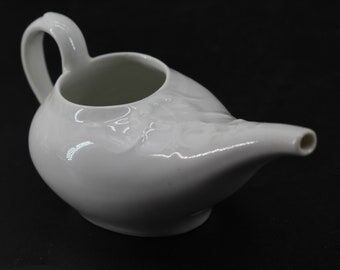 Old white earthenware sausage