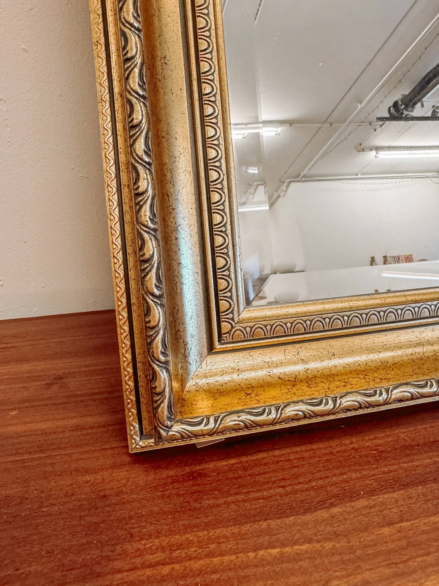 XL vintage bevelled mirror with a gold frame.