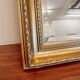 XL vintage bevelled mirror with a gold frame.
