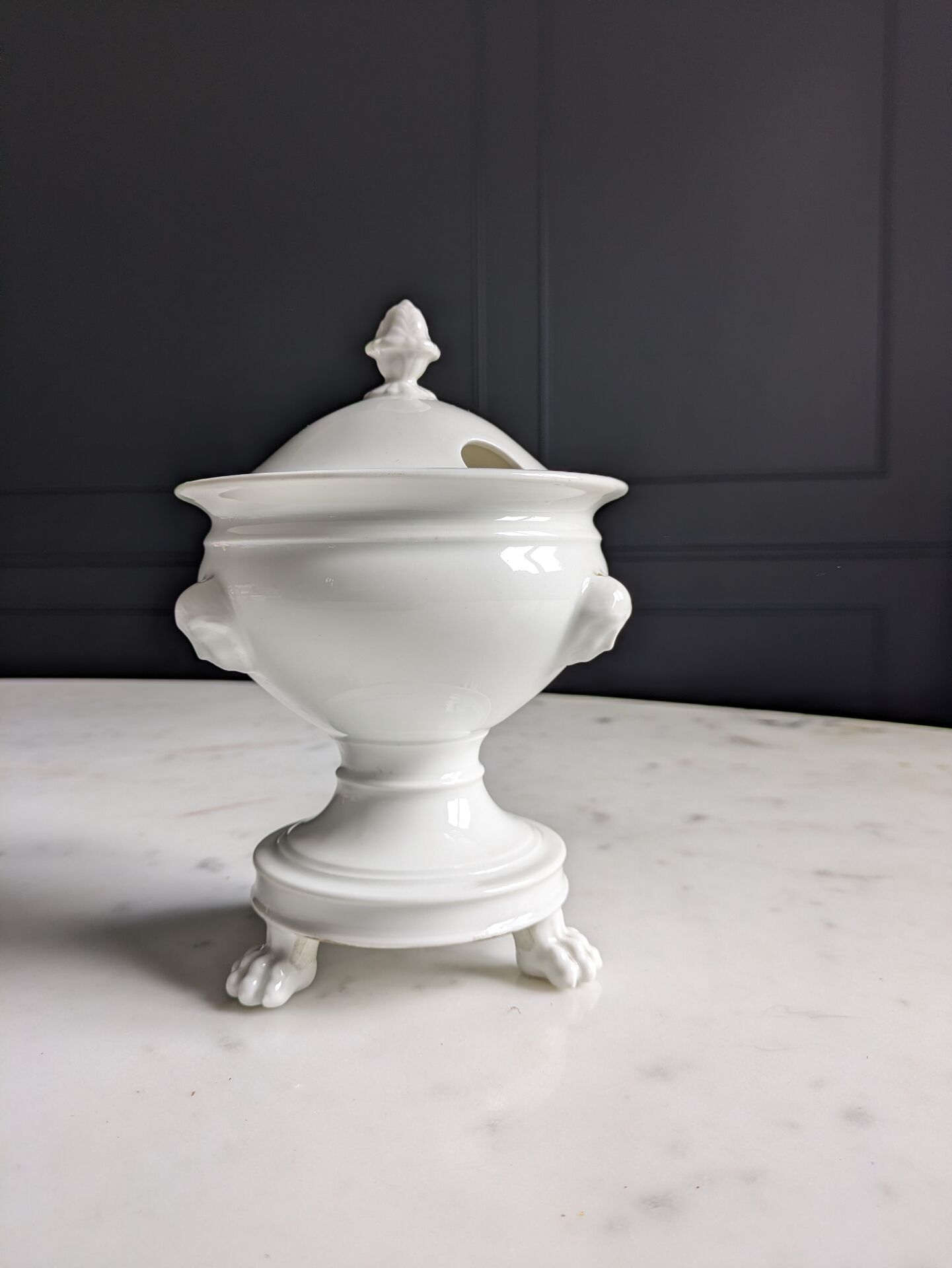 White porcelain confiturier with lion paws and masks. 19th century.