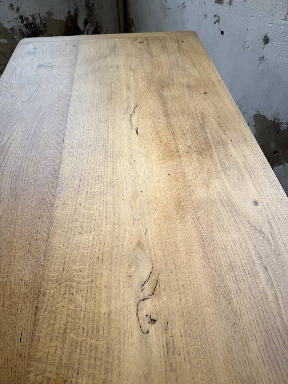 Oak farmhouse table with turned black legs.