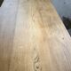 Oak farmhouse table with turned black legs.