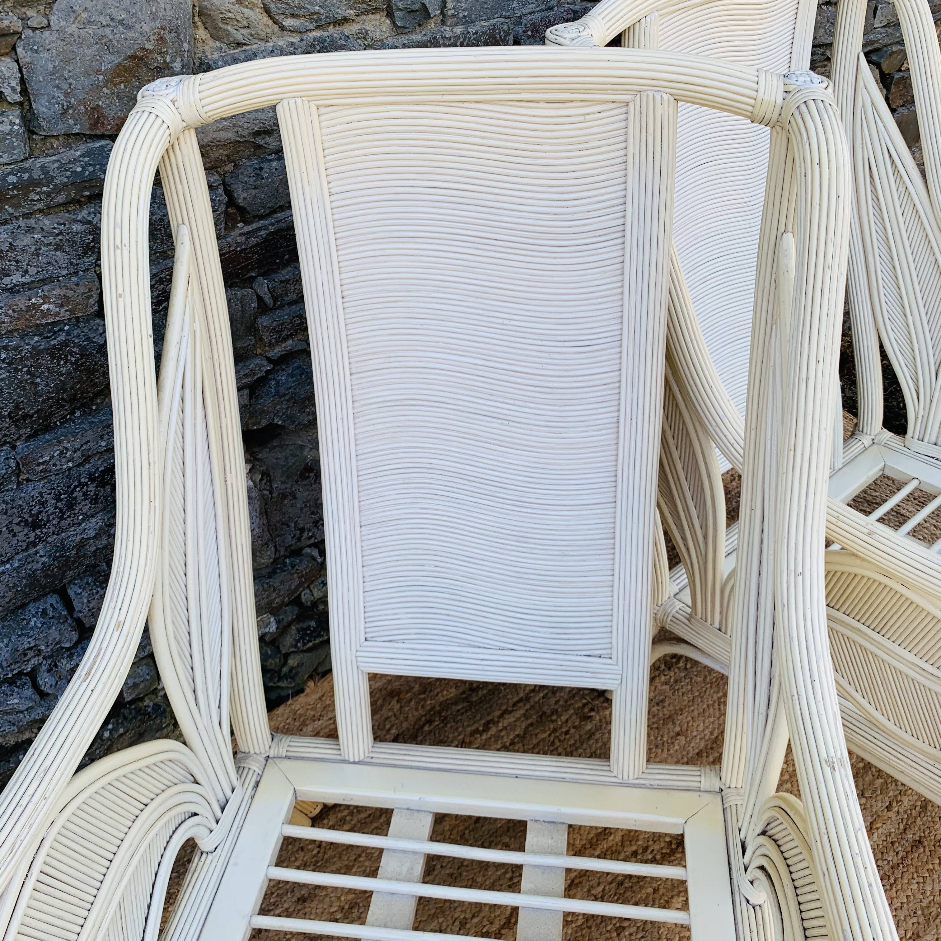 Pair of white rattan armchairs