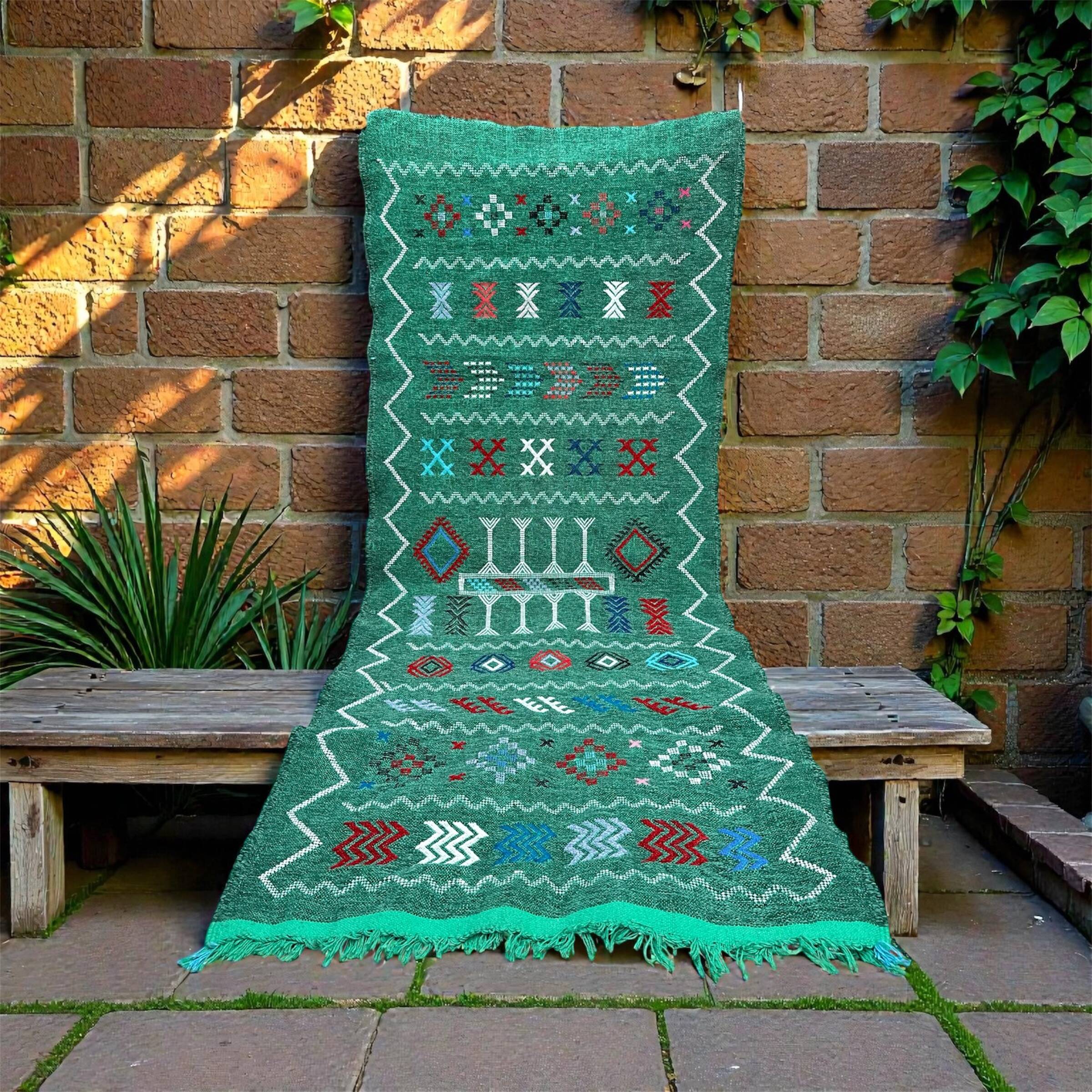 Handwoven green Moroccan hallway rug with geometric patterns.