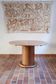 Round table with a central pedestal, light wood, 1990s.