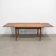 Vintage extendable dining table with tapered legs.