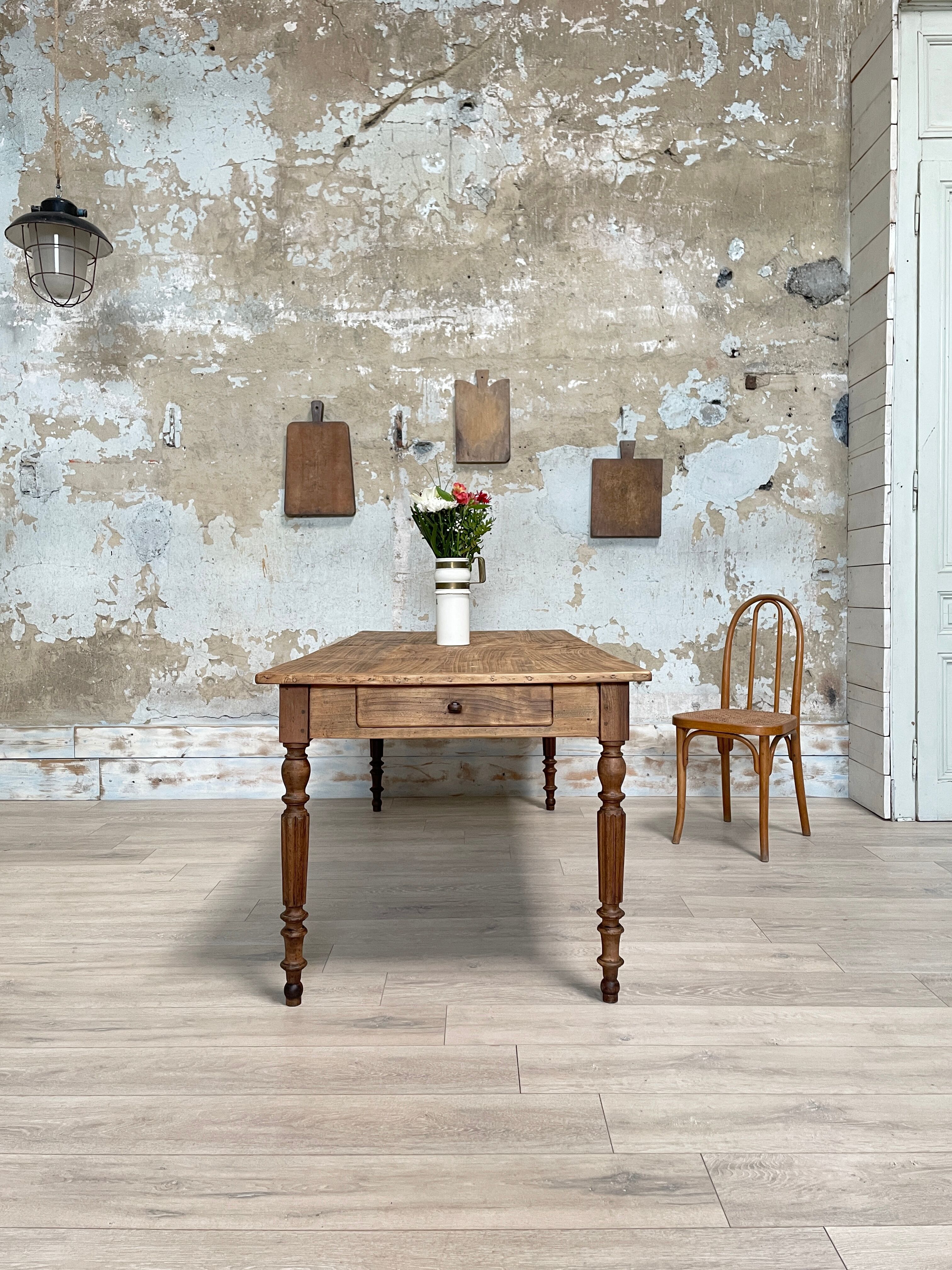 Vintage farmhouse table with turned legs.