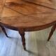 Antique half-moon walnut round table