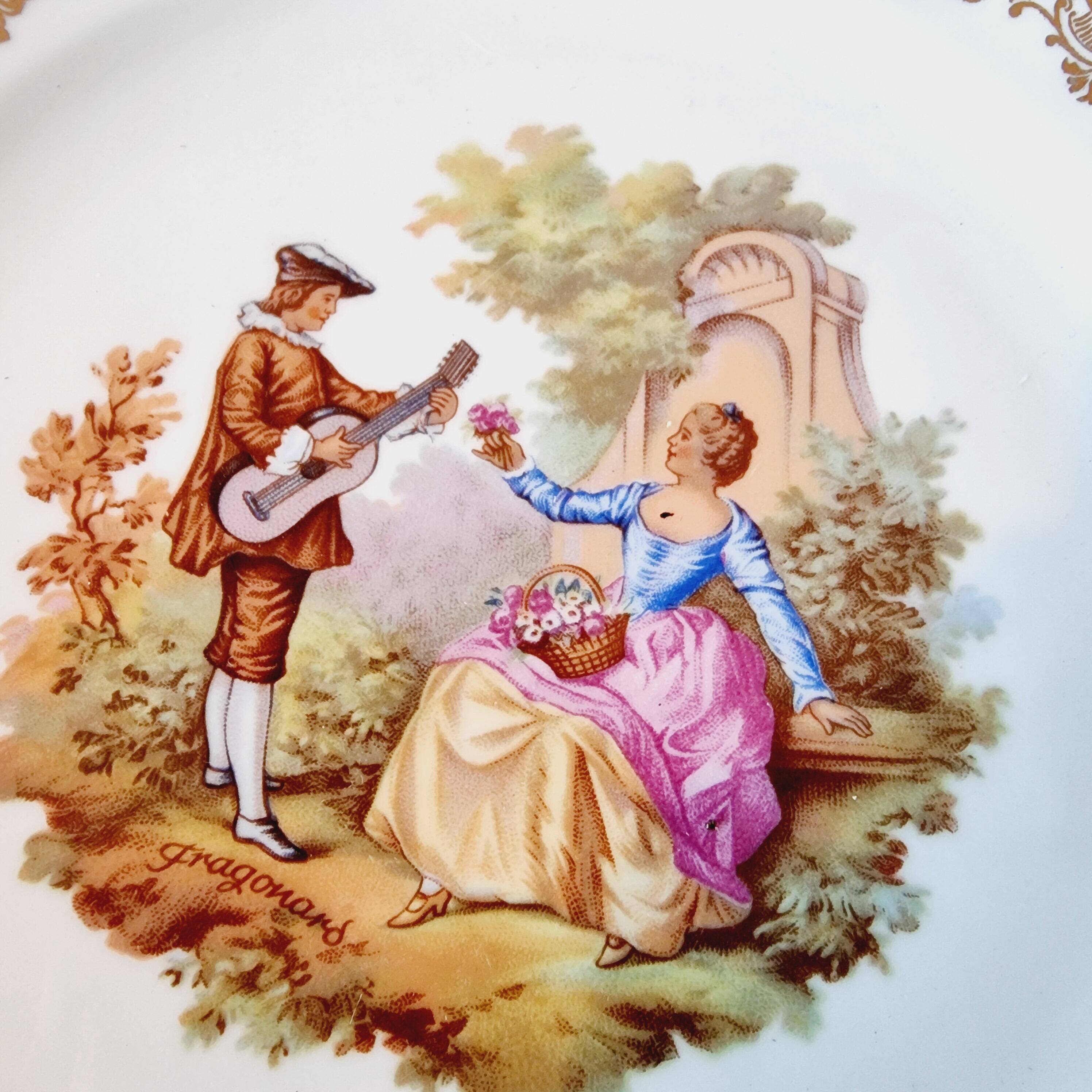 Large serving plate with romantic Frangonard scene with 24 carat gold