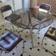 Round kitchen table with smoked glass top and 4 chairs from the 1970s.