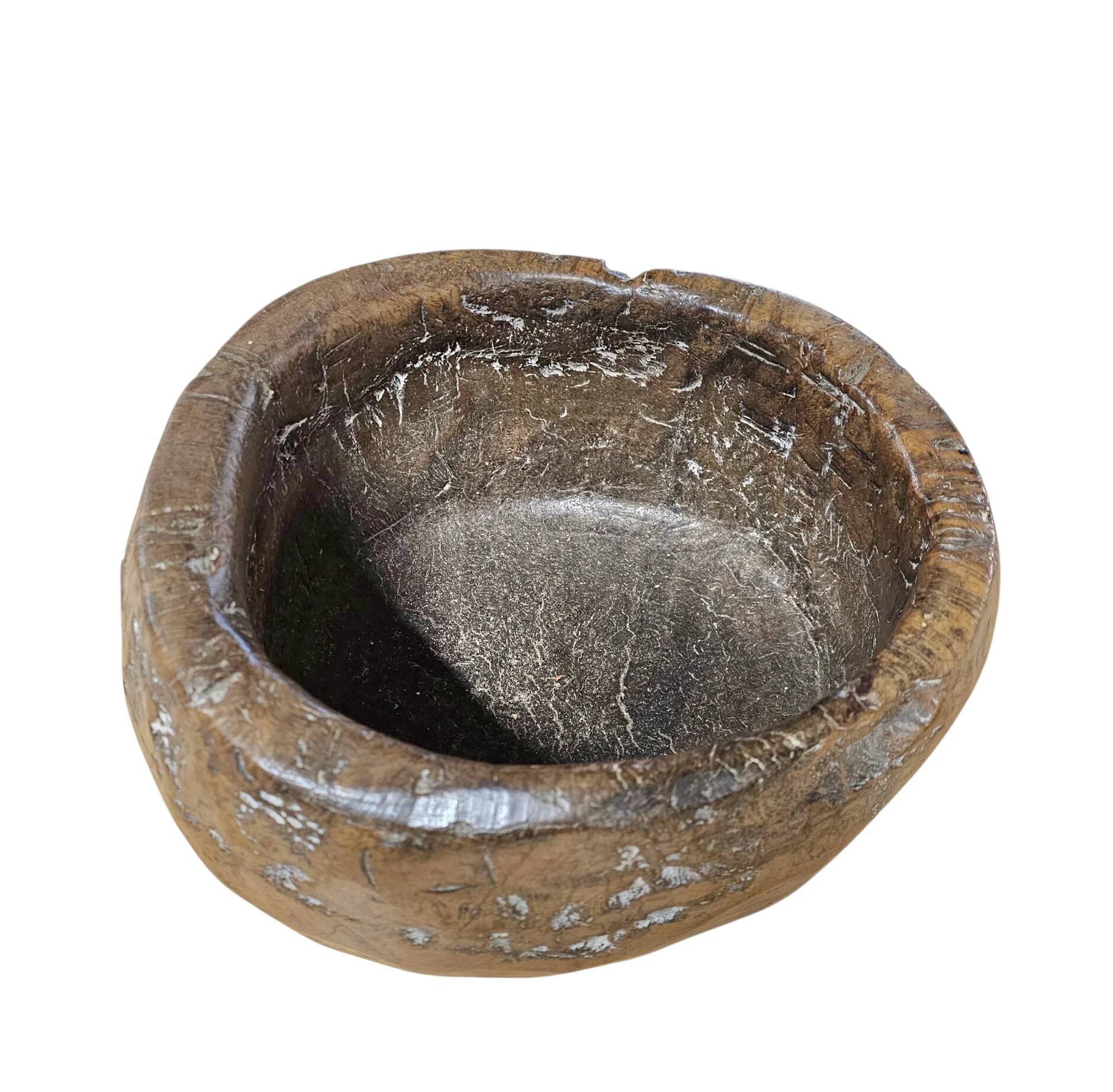 A substantial hand-hewn wooden bowl carved from a single burl section