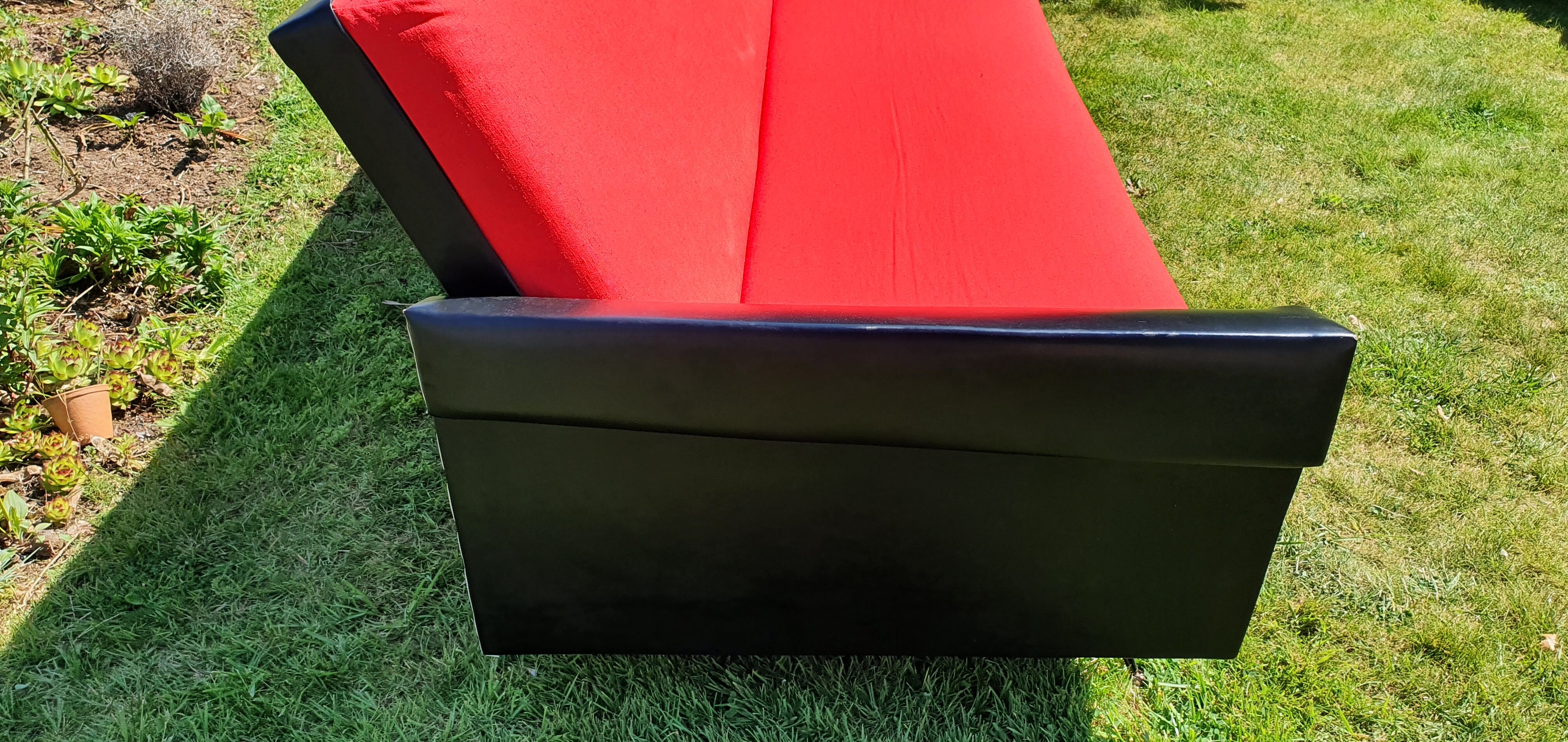 Vintage sofa 3 places convertible, red fabric and black skaï.1960s.