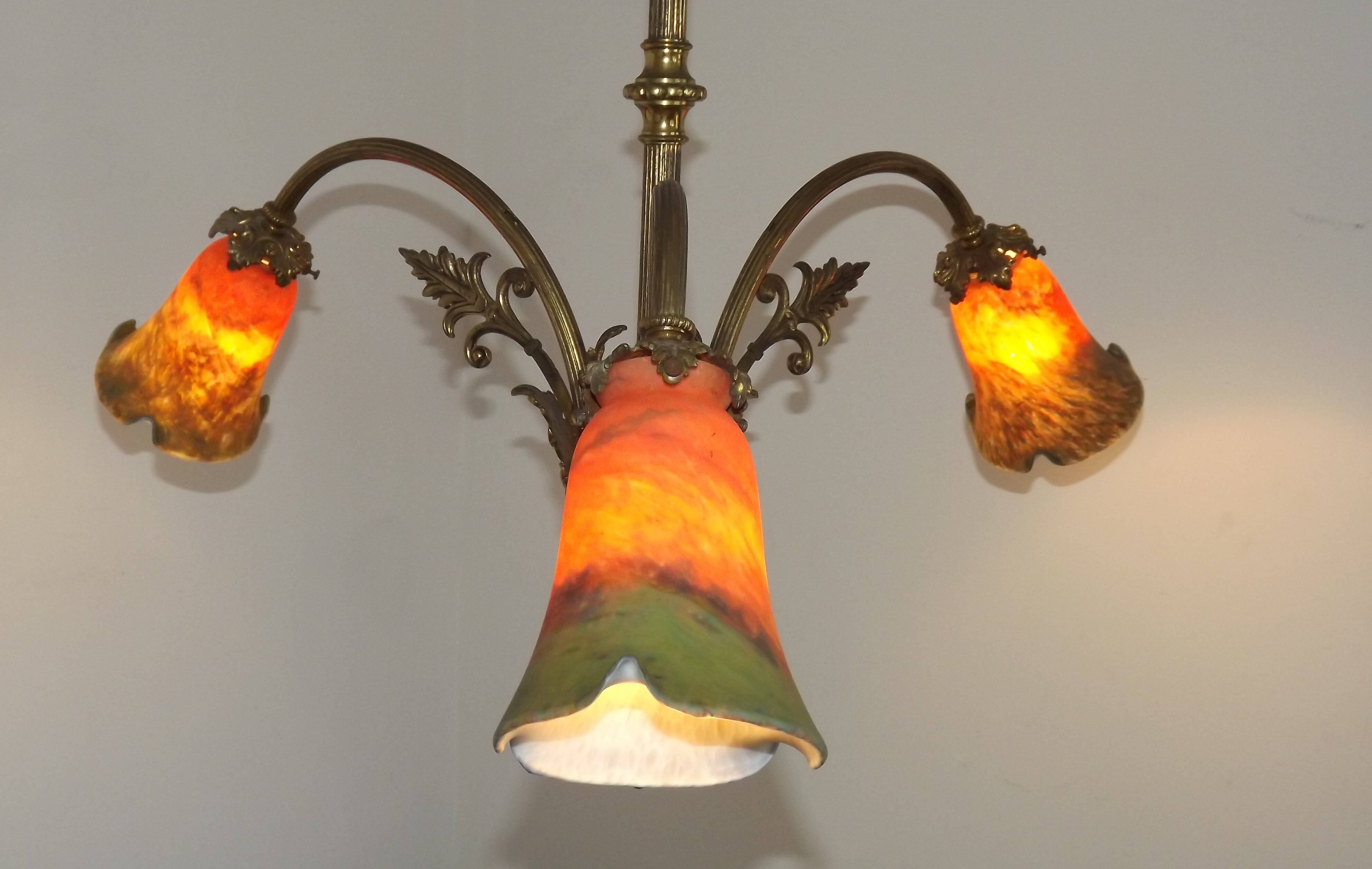 Art Nouveau three-light chandelier in bronze with orange and green glass shade, France.