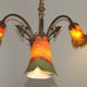 Lustre 3 feux Art Nouveau en bronze avec abat-jour en verre orange et vert, France