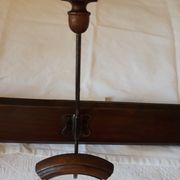 old wall coat holder made up of 3 wooden and metal pads.