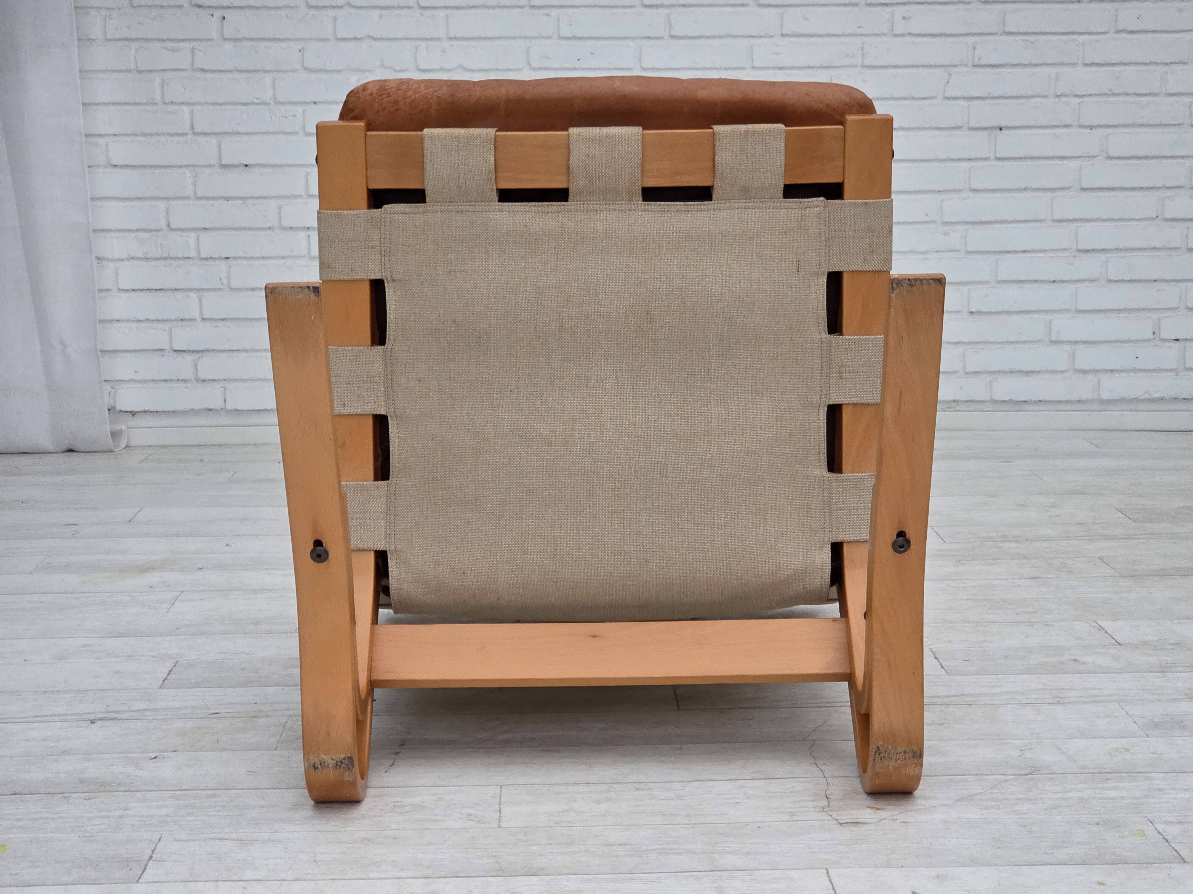 Fauteuil norvégien des années 1970, modèle "Kengu", cuir de meuble.