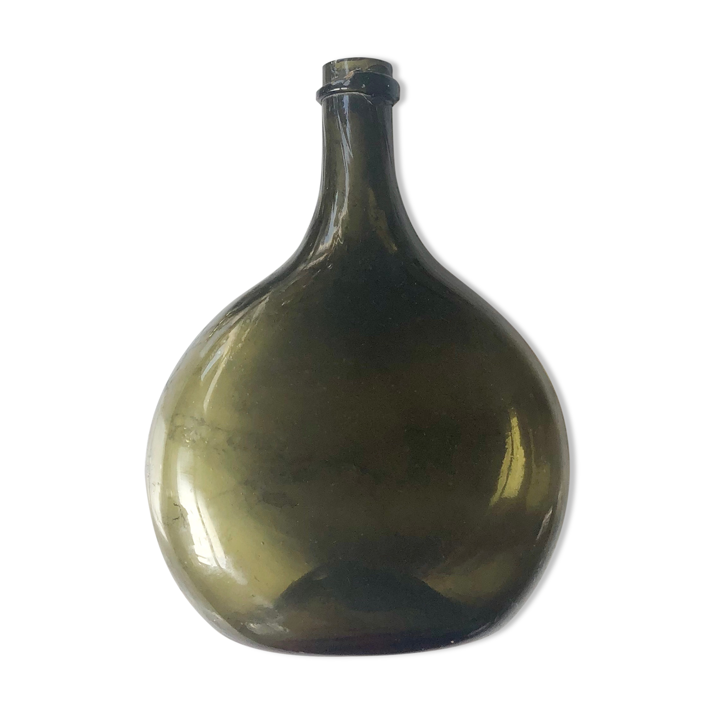 Old rum bottle in thick puffed glass in dark green color