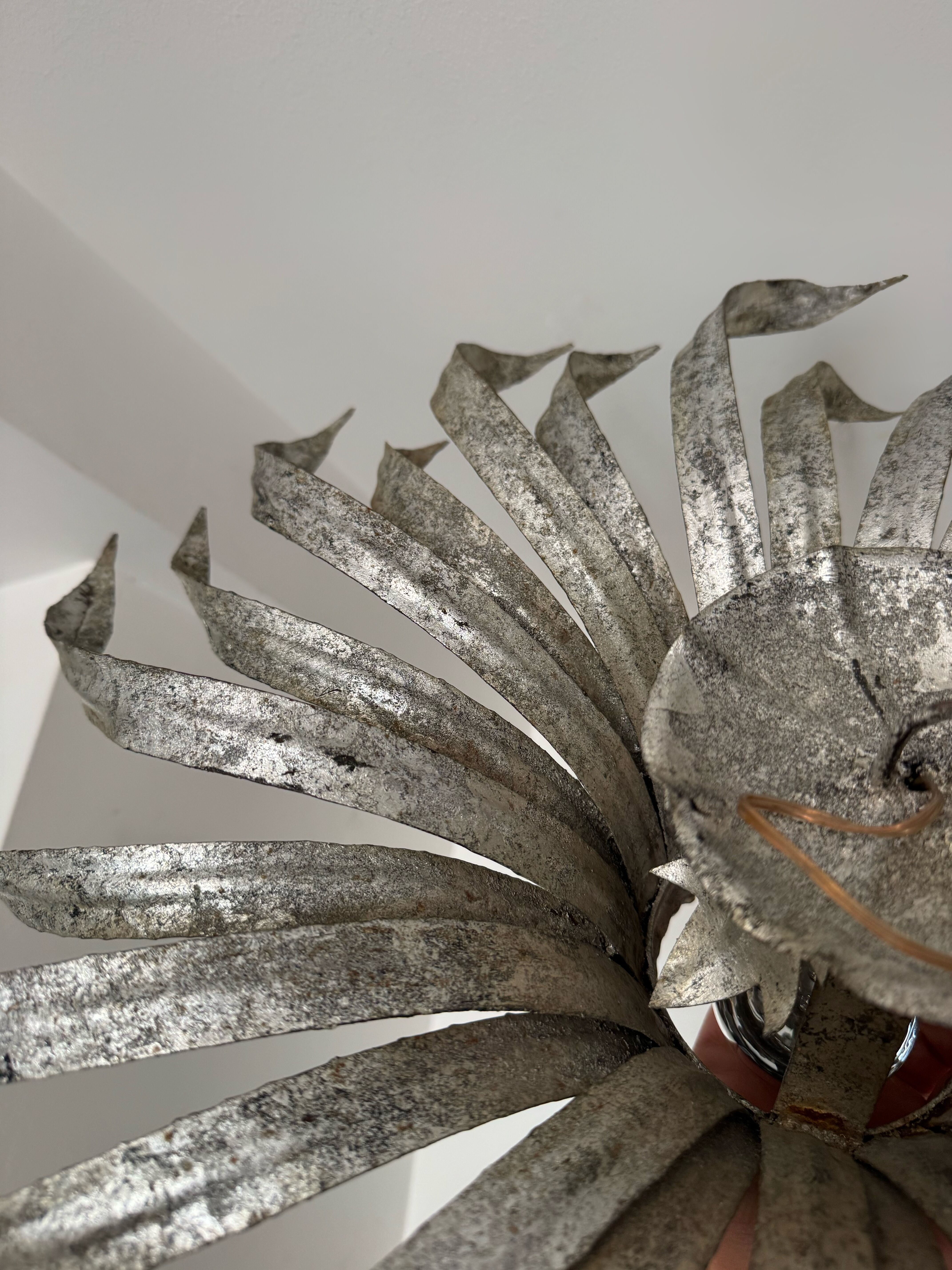 Silver wrought iron sunburst wall light from the 1960s.