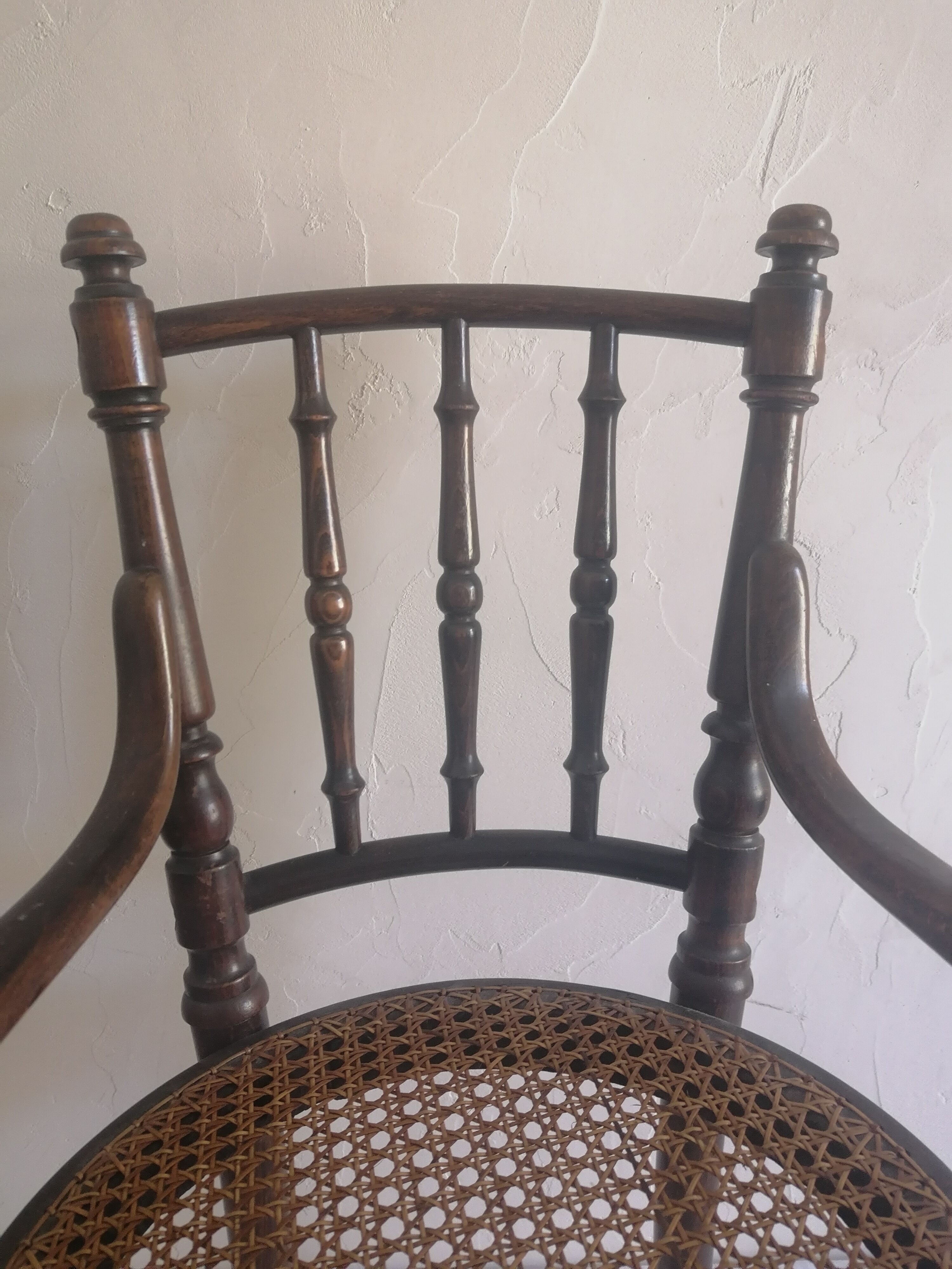 Old children's armchair in curved wood. Fischel