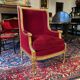 Golden wooden bergère in Louis XVI style upholstered in Bordeaux velvet.